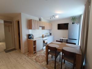 a kitchen with a table and chairs and a refrigerator at Audringa in Nida +12 photos