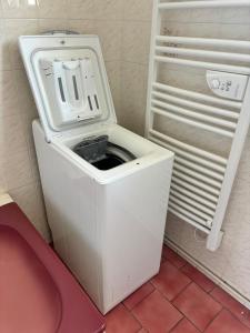 a white washing machine sitting in a room at Chez Colette, maison agréable in Villebernier