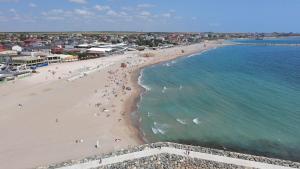 an aerial view of a beach with people in the water at Hostel Delfinul Albastru in Costinesti