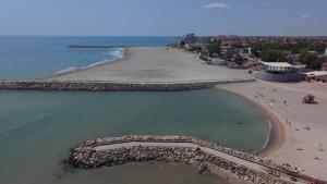 an aerial view of a beach with people in the water at Hostel Delfinul Albastru in Costinesti