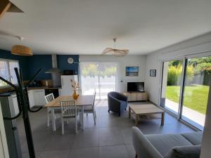 a living room with a couch and a table at Gites Les Mondaines - Les hirondelles in Favières
