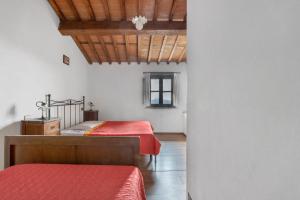 a bedroom with two beds and a wooden ceiling at Villa Chelucci - Gualdo in Massarosa +110 photos