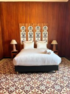 a bedroom with a large bed and two lamps at Appartements Balima Résidences Sidem in Rabat +119 photos
