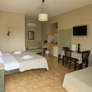 a hotel room with two beds and a kitchen at Nicolas Beach in Palaiochora