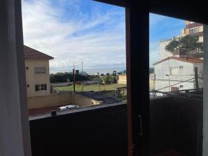 an open window with a view of a building at A pasos del mar in San Bernardo