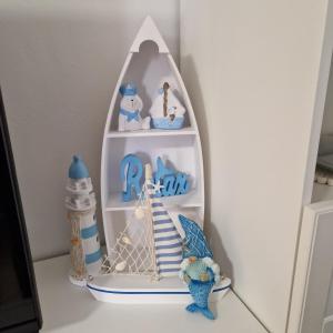 a shelf with a lighthouse and figurines on it at Apartment CHARLY in Supetar