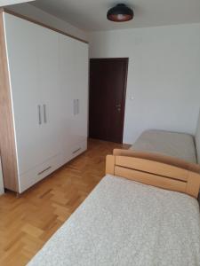 a bedroom with two beds and a closet at Luxury Apartment in Strumica