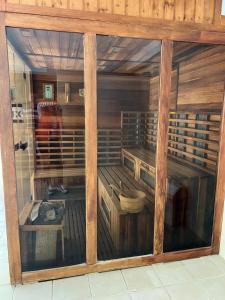 a display case in a room with wooden walls at Golden-Beach Apartman in Siófok