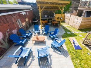 an outdoor patio with blue chairs and a table at Jennifer's Penthouse 2 Floor Apartment - Amazing City View in Providence