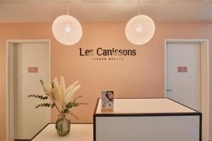 a waiting room with two pendant lights and a counter at Odalys Résidence et Spa Les Canissons in Cavalaire-sur-Mer