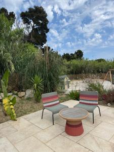 two chairs and a table on a patio at Residence Paolina in Calvi