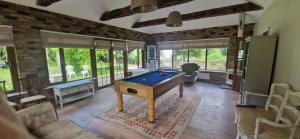 a living room with a pool table in it at Farm House Cottage in Baltinglass