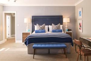 a bedroom with a large bed with a blue blanket at Harbour Hotel & Spa St Ives in St Ives