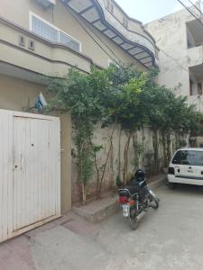 a motorcycle parked in a parking lot next to a building at HEAVEN House in Dargai
