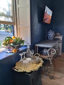 a blue room with a table with glasses on it at Olive grove cottage in Koringberg