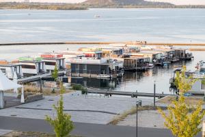 a group of boats docked at a dock on a lake at Hausboot EL-SOL in Braunsbedra