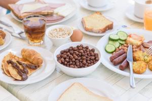 a table topped with plates of food and drinks at Bellini Hotel in Ayia Napa