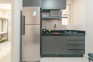 a stainless steel refrigerator in a kitchen at Apartamento Confortável - MEL402 in Maringá