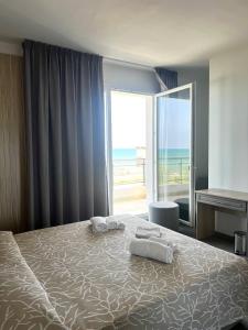Postel nebo postele na pokoji v ubytování Hotel Marechiaro - Direttamente sul mare