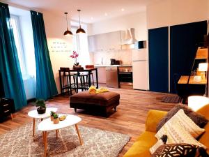 a living room with a couch and a kitchen at 1 Liberte - 3a in Saint-Affrique
