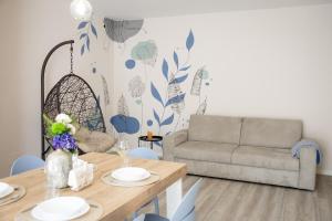 a living room with a table and a couch at Il Confine Azzurro in Porto SantʼElpidio
