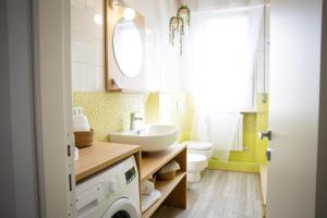 a bathroom with a sink and a washing machine in it at Il Confine Azzurro in Porto SantʼElpidio +42 photos