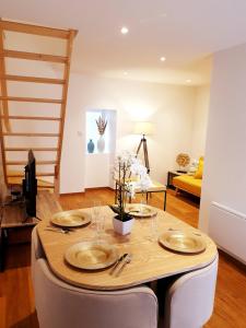 a dining room with a table with plates on it at sadi carnot - 2b duplex in Millau