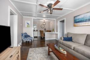 a living room with a couch and a ceiling fan at Bluestar Cottage - Hot Tub Pergola and Fire pit in Saugatuck +15 photos