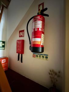 a fire hydrant hanging on the wall of a room at Casa dos avós in Maceira