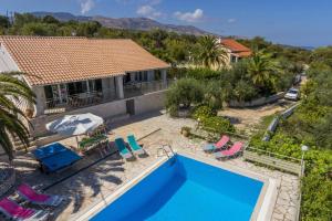 an aerial view of a house with a swimming pool at Villa Petra by Villa Plus in Ágios Stéfanos