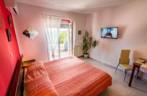 a bedroom with a bed and a sliding glass door at Apartments Borghese in Pula
