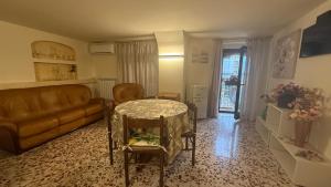 a living room with a couch and a table at Agira Royal Central Rooms in Agira
