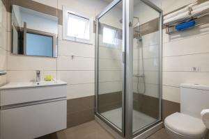 a bathroom with a shower and a toilet and a sink at Bellini Hotel in Ayia Napa