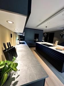 una cucina con mobili neri e un piano di lavoro di Lofoten Luxe Retreat a Leknes Altre 20 foto
