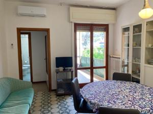 Una sala de estar con una mesa y un televisor. en Appartamenti Torre Medicea, en Castiglioncello
