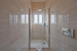 a shower with a glass door in a bathroom at Gaspar House in Lisbon +76 photos
