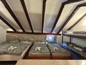 a room with three bunk beds in a attic at Kuća za odmor Krasnica in Novi Vinodolski