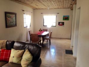 a living room with a couch and a table at Residencias Bp in Constanza