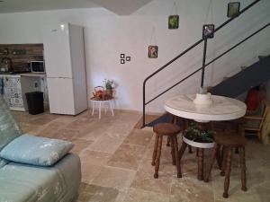 a living room with a couch and a table and stairs at les noisetiers de verinas in Rochechouart +6 photos