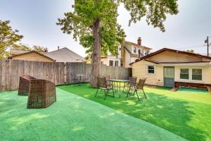 a backyard with a table and chairs and a fence at Cozy Keansburg Cottage Walk to Beach and Boardwalk! in Keansburg