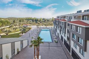 an aerial view of a building with a swimming pool at Ramada Resort Kazdağlari Thermal & Spa in Gure