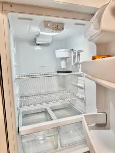 an empty refrigerator with its door open at Cozy 1 Bedroom Apartment 10 minutes to SeaTac Airport in Seattle