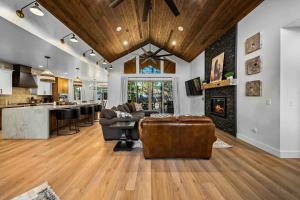 a kitchen and living room with a couch and a fireplace at Lake-View Gem w/ Outdoor Entertainment in Show Low in Show Low