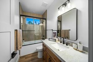 a bathroom with a sink and a toilet and a mirror at Lake-View Gem w/ Outdoor Entertainment in Show Low in Show Low +29 photos
