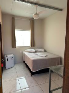 a bedroom with a bed and a window at Pousada dos Azevedo in Cláudio +89 photos