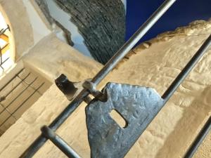 a metal latch on top of a clock tower at Romantic Corner in Alberobello +13 photos