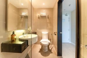 a bathroom with a toilet and a sink at Centrestage PJ by Master House in Petaling Jaya
