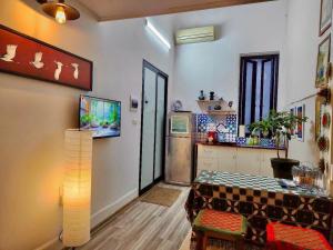 a living room with a table and a kitchen at Hanoian Traditional Stay - City view - Old Quarter in Hanoi
