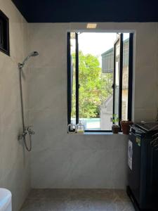 a bathroom with a shower with a window and a window at Hanoian Traditional Stay - City view - Old Quarter in Hanoi +42 photos
