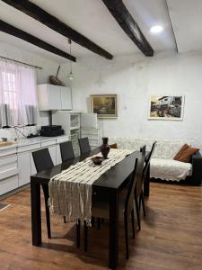 a kitchen and dining room with a table and chairs at Cottage Modrich in Struga